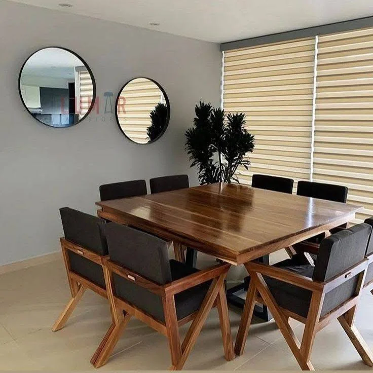 Stylish dining room featuring a modern wood table and chairs, enhanced by circular mirrors.