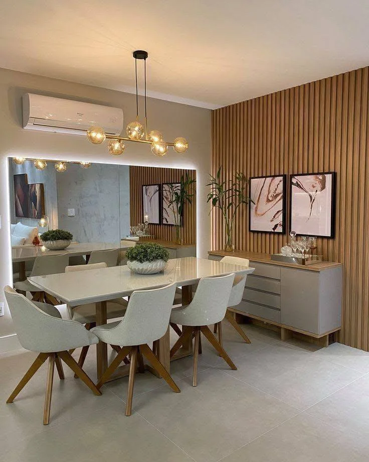 Contemporary dining room with a vertical wood-paneled accent wall and a large, illuminated mirror.