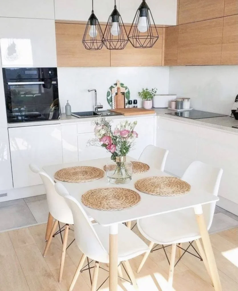 Bright Scandinavian kitchen and dining area with a white table and natural accents.