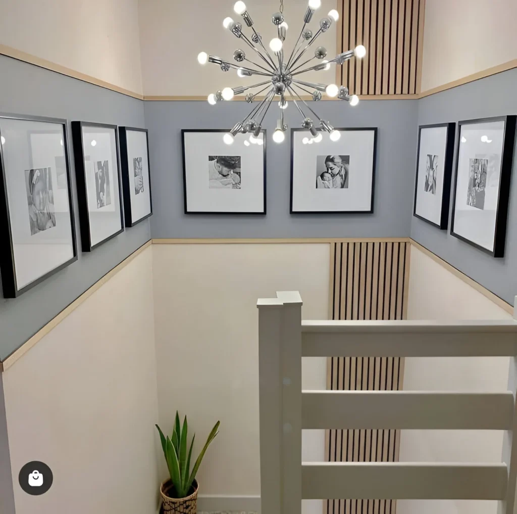 Symmetrical gallery wall using acoustic slat wall panels in a small space.