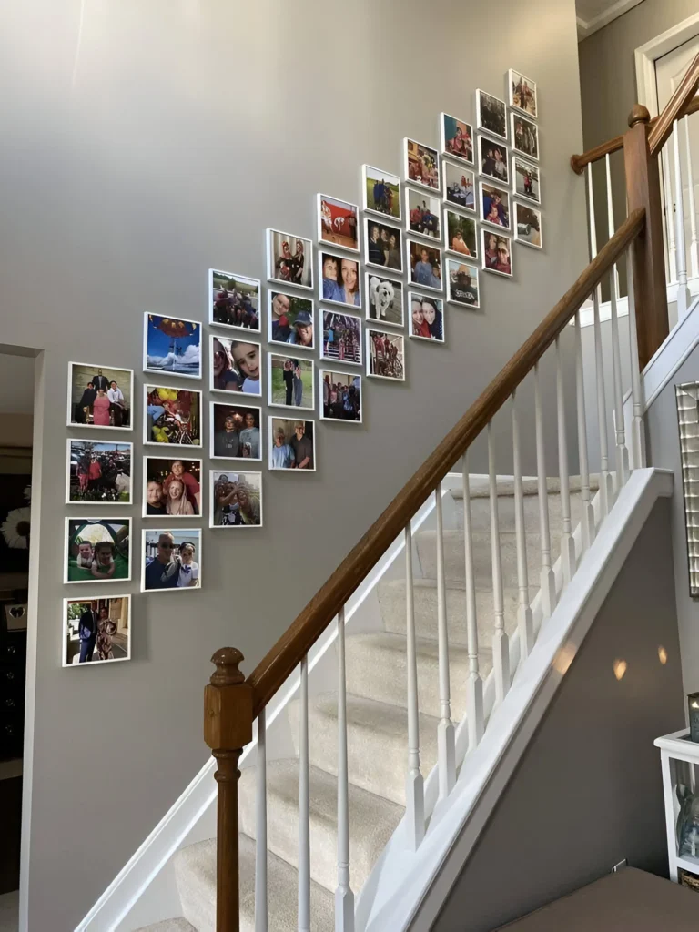 DIY gallery wall ascending a staircase, perfect for small space design.