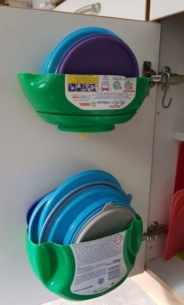 DIY pot lid storage using repurposed laundry detergent containers.