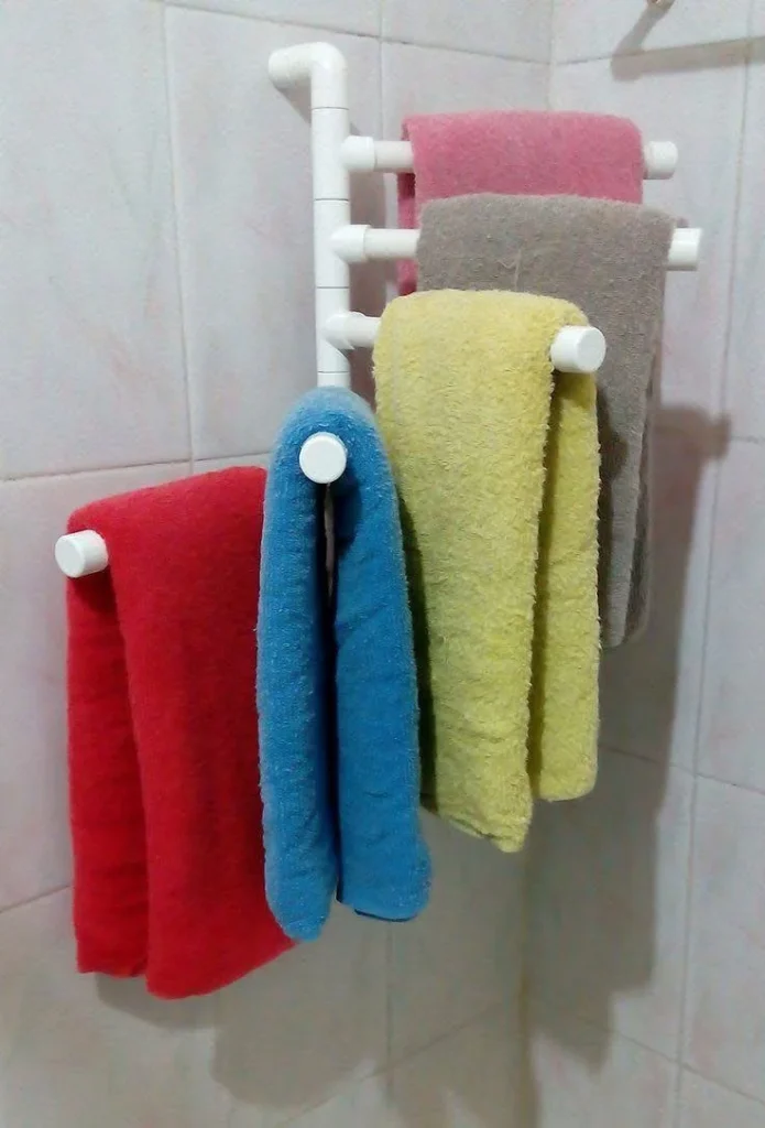 DIY towel rack made from PVC pipes for bathroom organization.