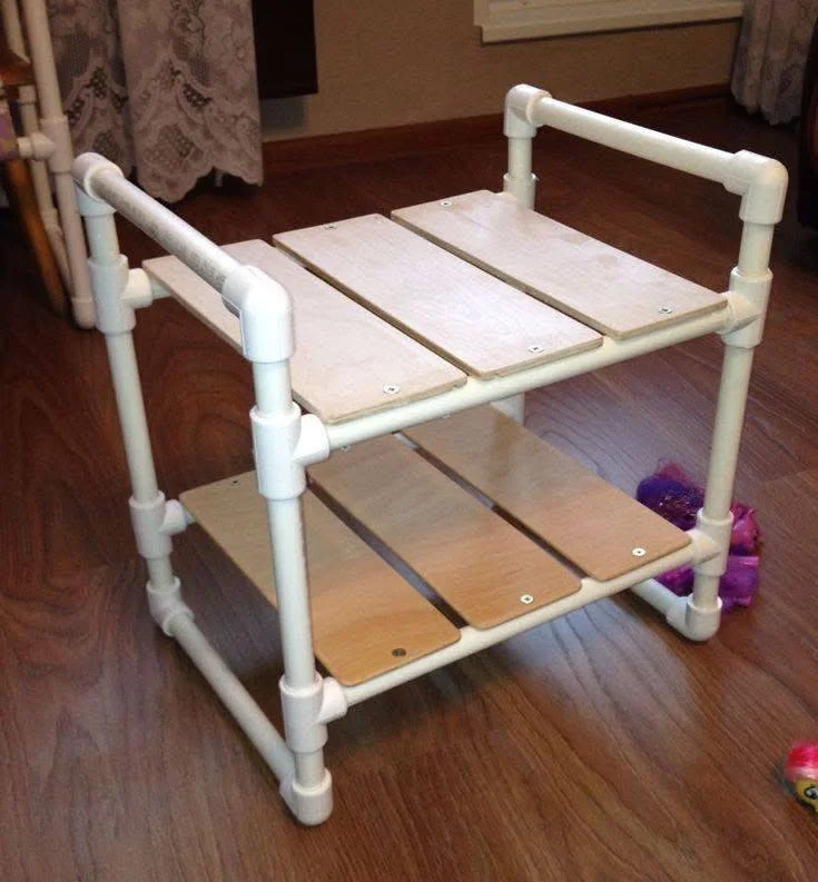 Custom DIY shelf made from PVC pipes and wood planks.