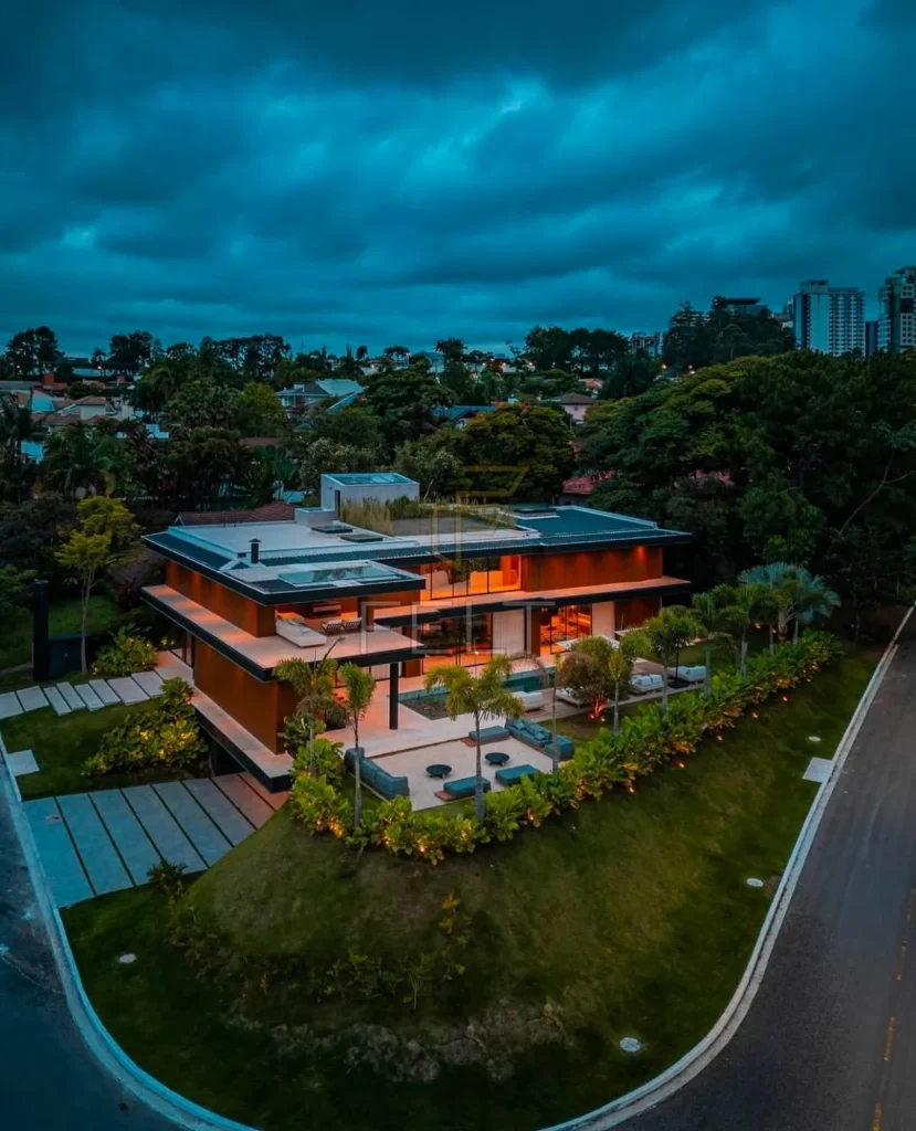 Luxury dream home exterior with wood and glass, hillside location.