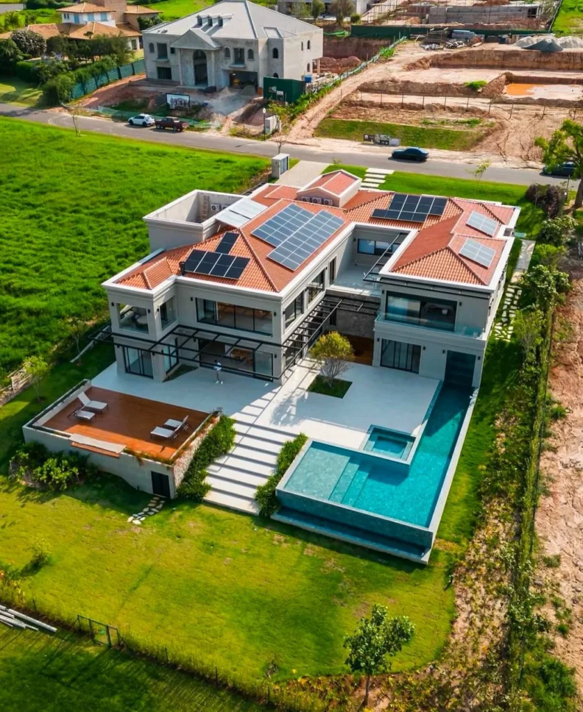 Luxury dream home exterior with solar panels and terracotta roof.