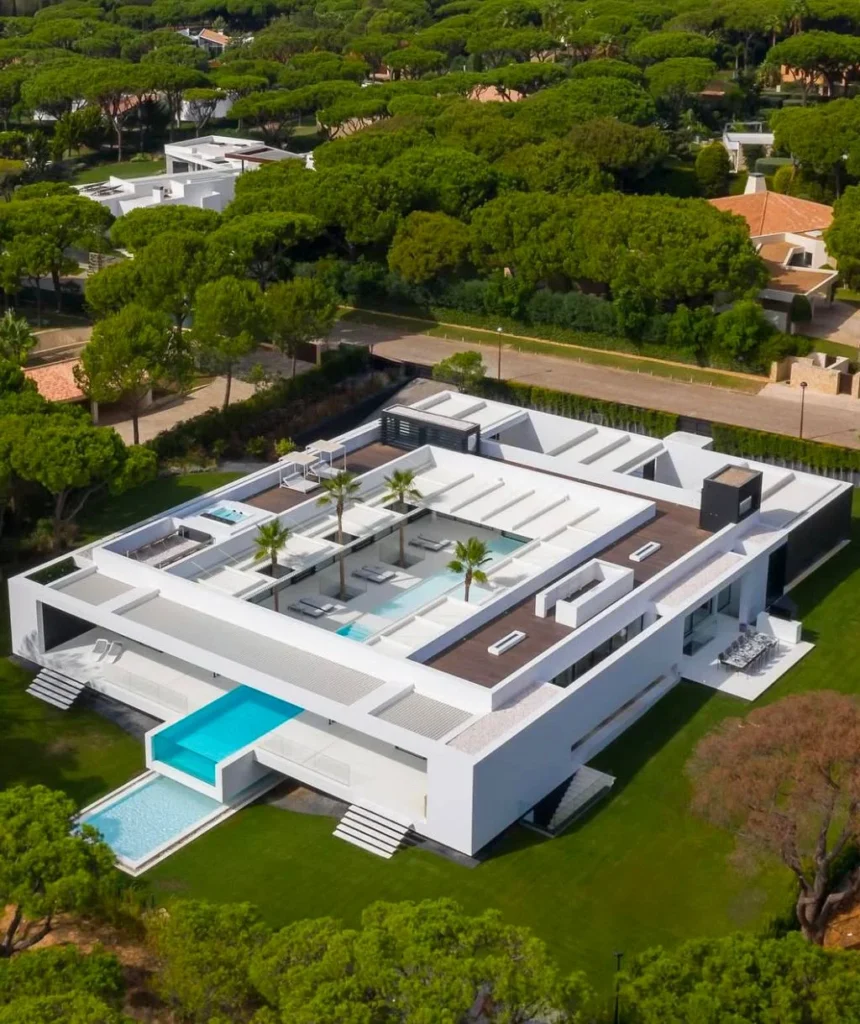 Modern luxury dream home exterior with rooftop pool and terraces.