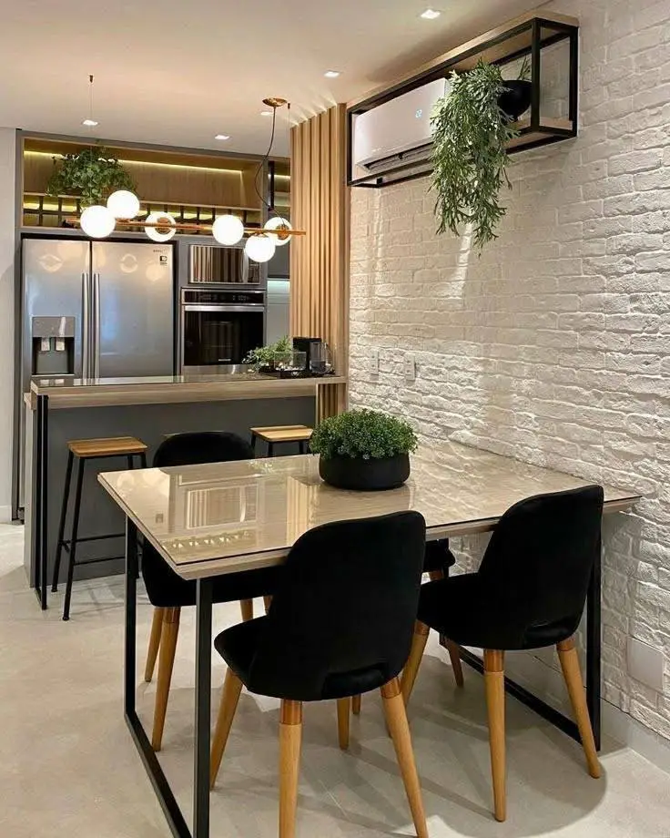 Modern industrial dining room with exposed brick and black chairs.