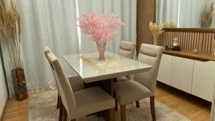 Modern dining room with plush rug and wood paneling.