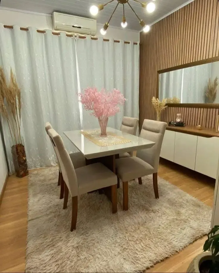 Modern dining room with plush rug and wood paneling.