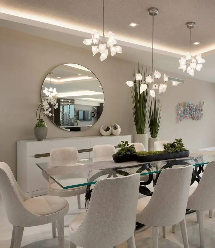 Modern dining room with sculptural lighting and glass table.