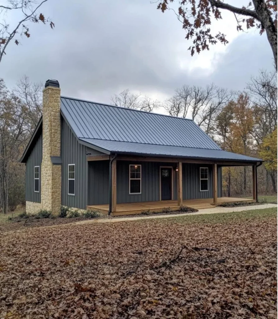 Modern farmhouse with wood siding, stone chimneys, and large deck.