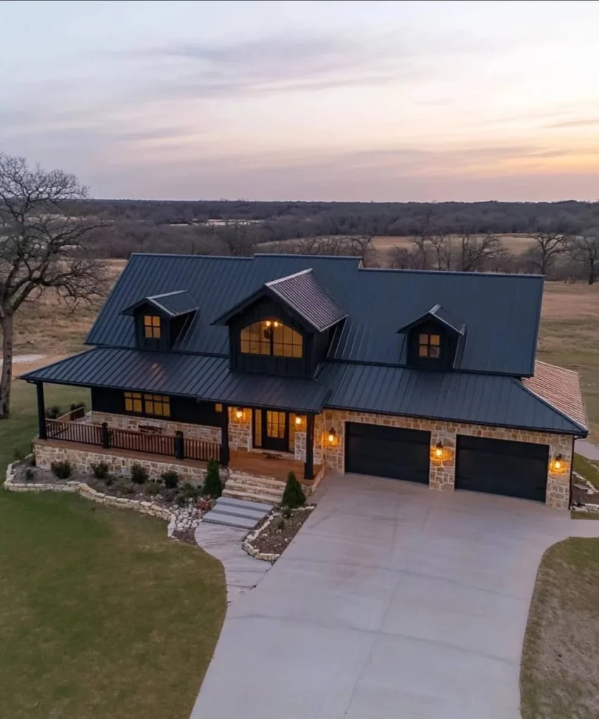 Modern farmhouse with stone accents, metal roof, and dormer windows.