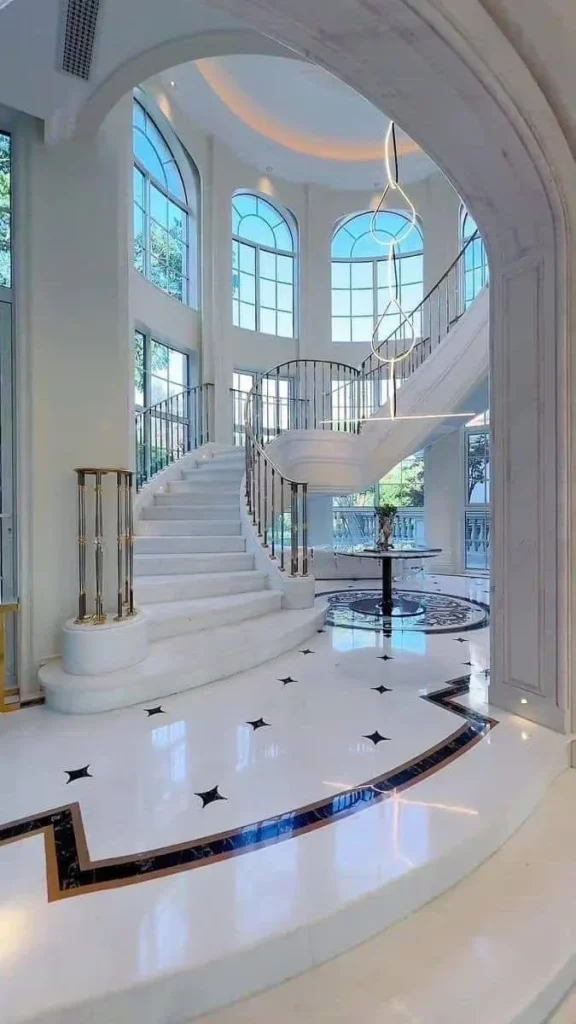 Grand staircase, marble construction, luxury home interior, elegant design.