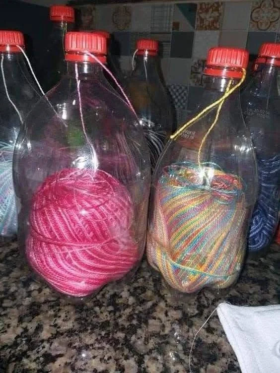 Recycled plastic bottles used to store and dispense yarn neatly.