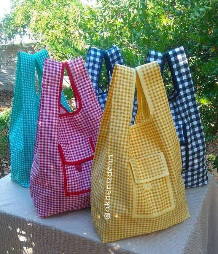 Recycled fabric repurposed into reusable shopping bags with pockets.