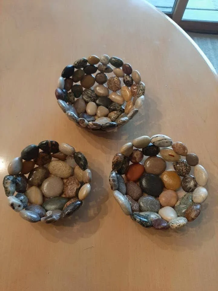 Handmade soap dishes made from recycled pebbles and epoxy resin.