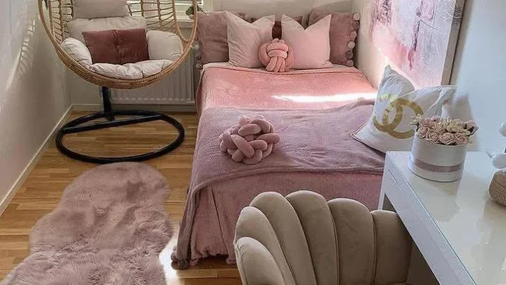 Small home organization idea featuring a hanging chair and wall-mounted desk in a pink and white bedroom.