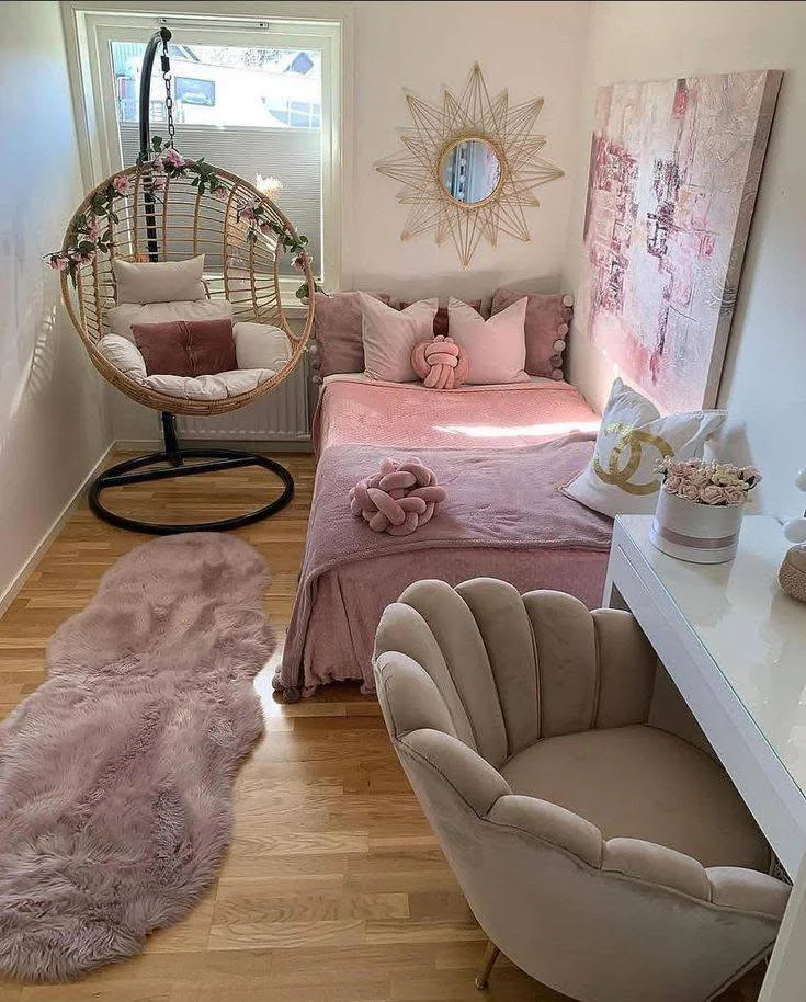 Small home organization idea featuring a hanging chair and wall-mounted desk in a pink and white bedroom.