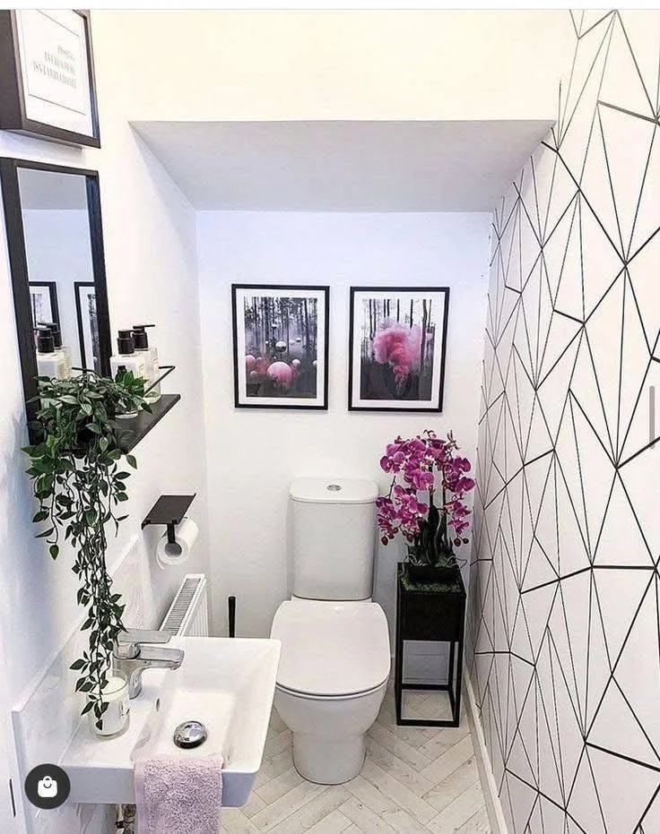 Small home organization idea featuring geometric wallpaper and space-saving fixtures in a small bathroom.