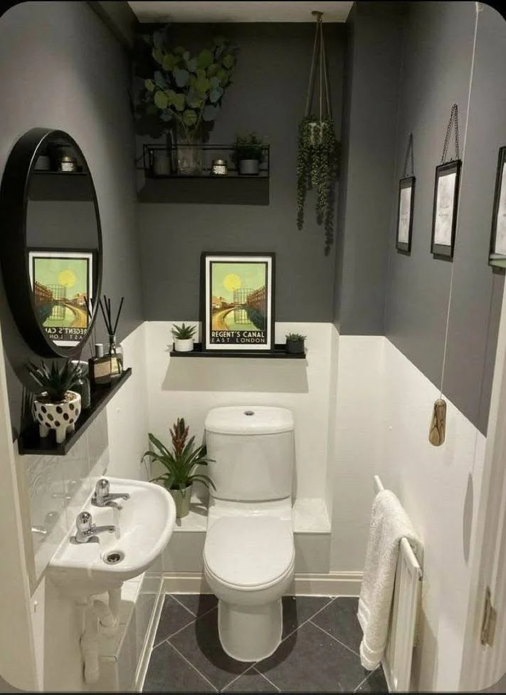 Small home organization idea showcasing a two-tone wall and floating shelves in a small bathroom.