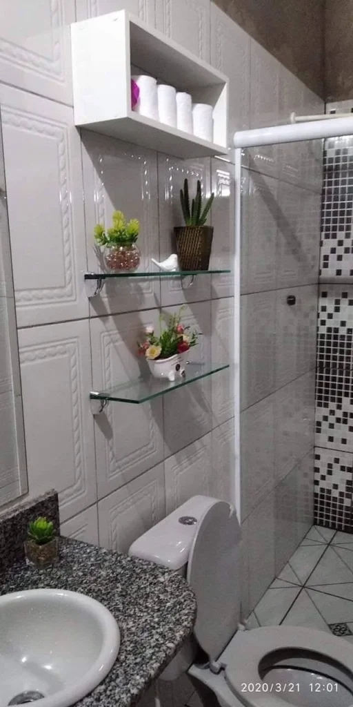 Small home organization idea featuring tiered shelving in a small bathroom.