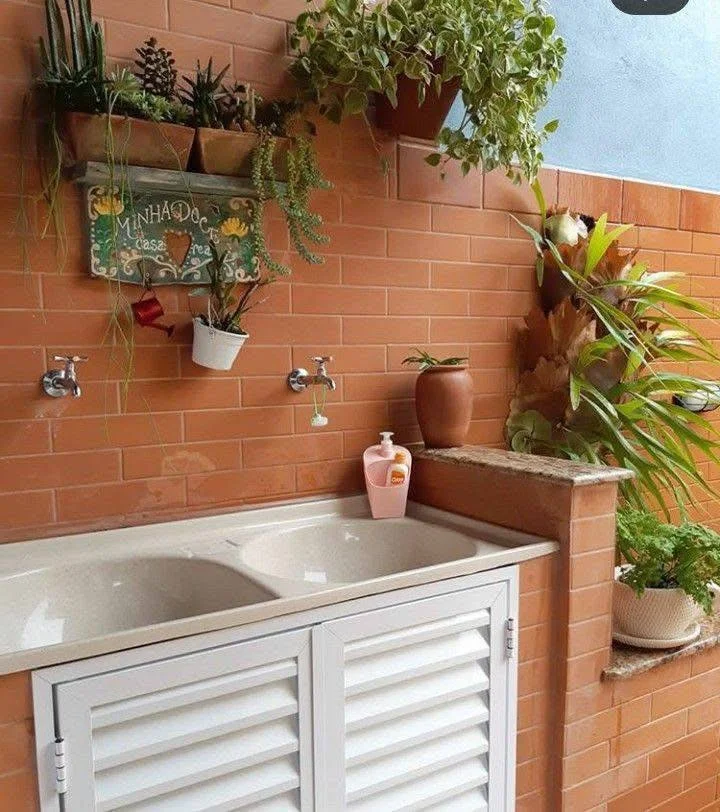 Small home organization idea with a vertical garden and storage in a laundry area.