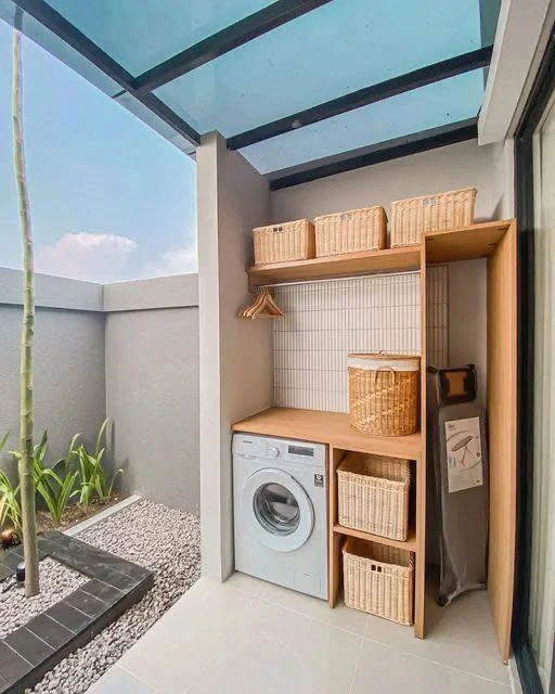 Small home organization idea featuring a streamlined laundry nook with custom shelving.