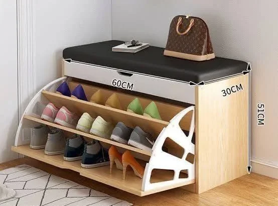 Shoe storage bench with angled shelves for organized shoe display and a padded top for seating.