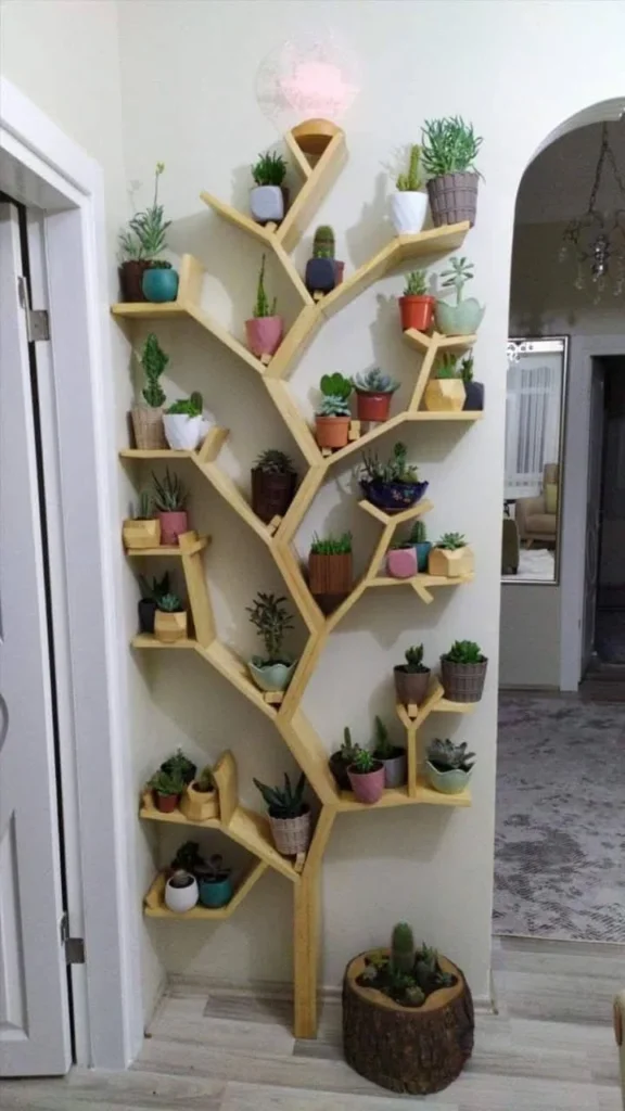 Tree-shaped wooden shelf mounted on a wall, displaying various potted plants. Creative home storage.