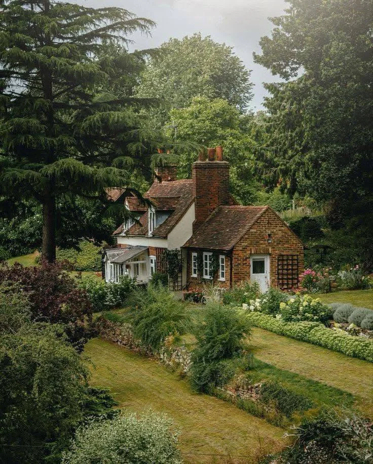 Homestead with brick and timber construction, surrounded by lush gardens.