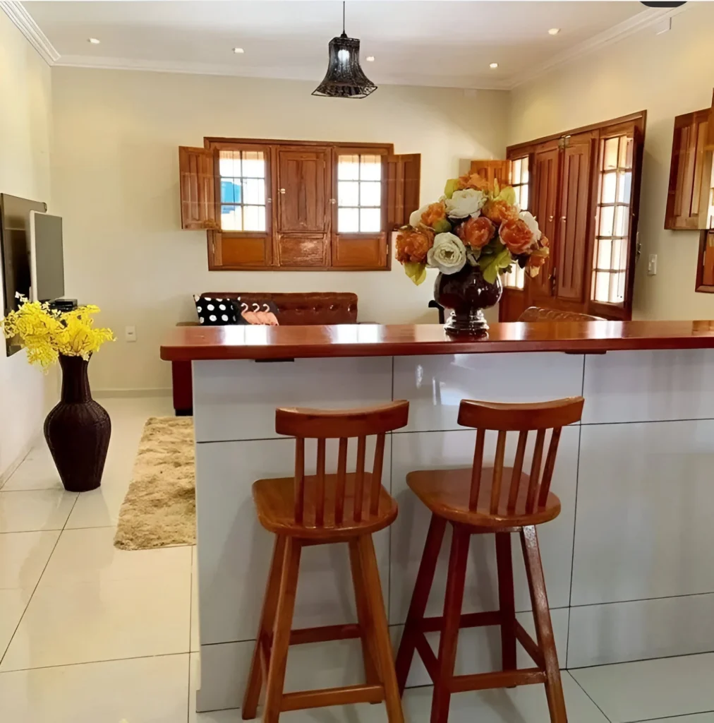 Kitchen bar with wood countertop and matching stools.