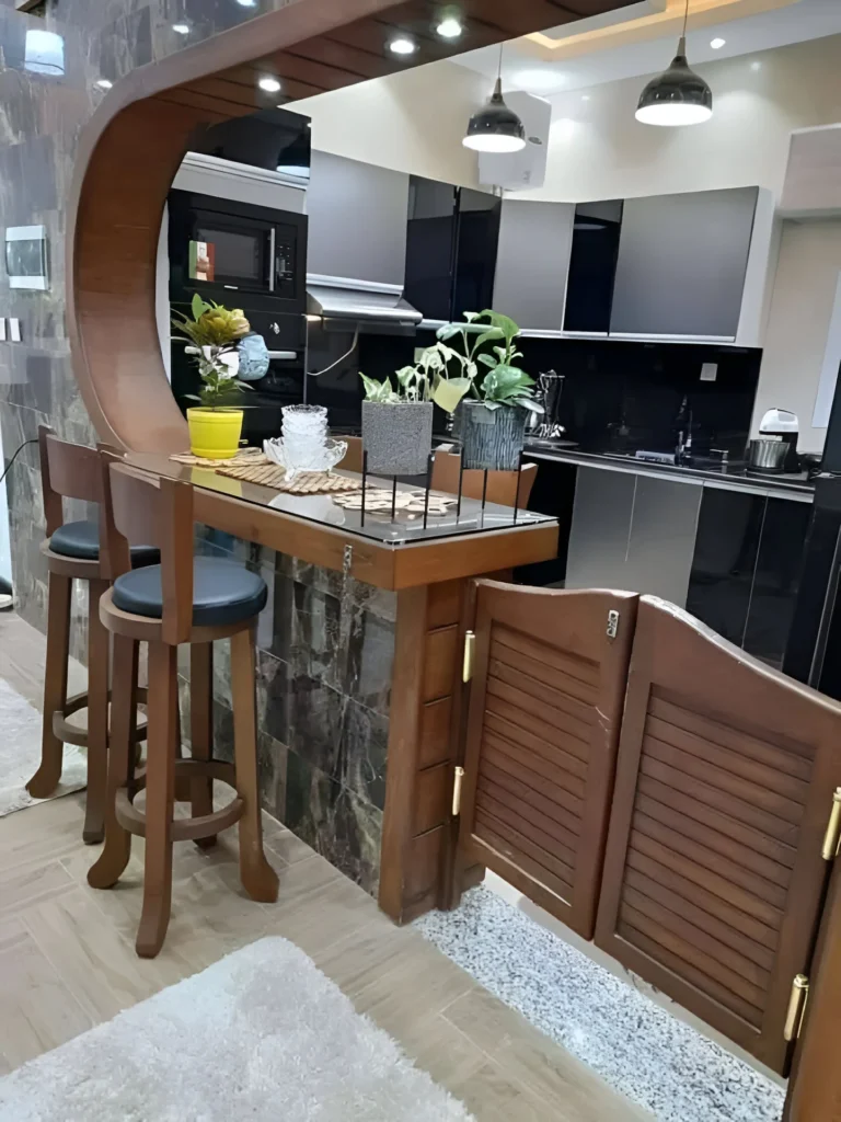 Curved kitchen bar with wood frame, glass countertop, and integrated cabinets.