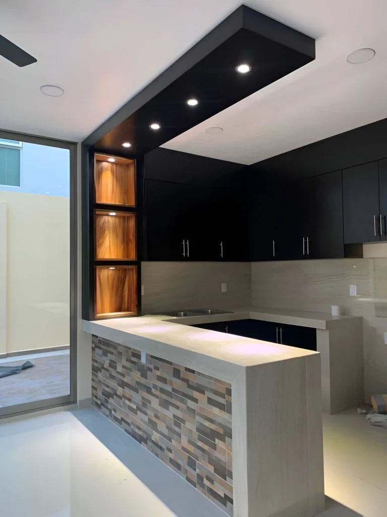 Kitchen bar with textured tile front and light countertop.