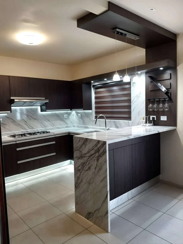 Kitchen bar with marble waterfall edge and dark cabinetry.