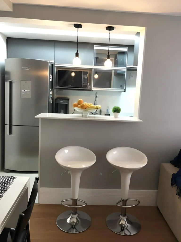 Simple white kitchen bar with white tulip-style stools.