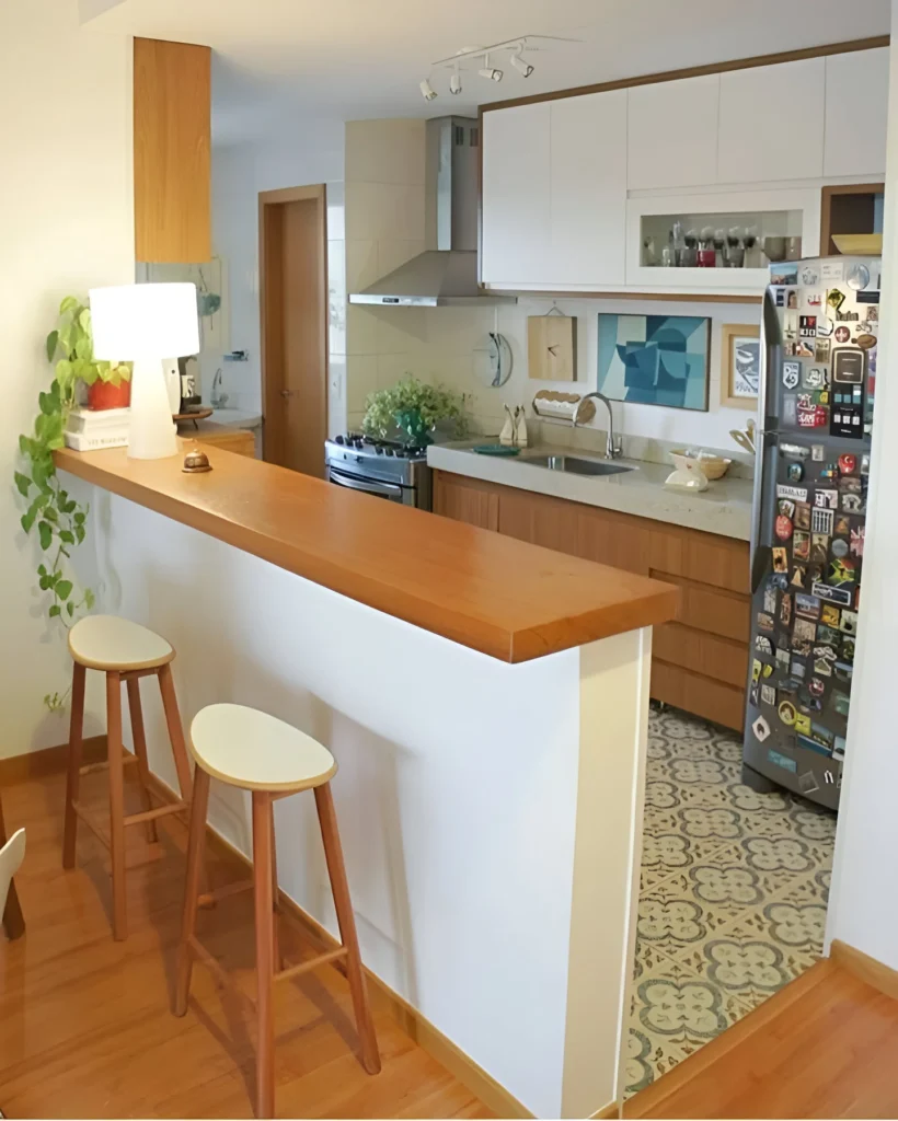 Slim kitchen bar with wood countertop and two-tone stools, space-saving design.