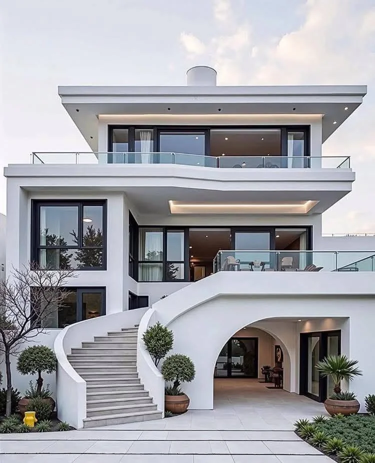 Modern house design with curved architectural staircase, glass railings, and multi-level balconies.