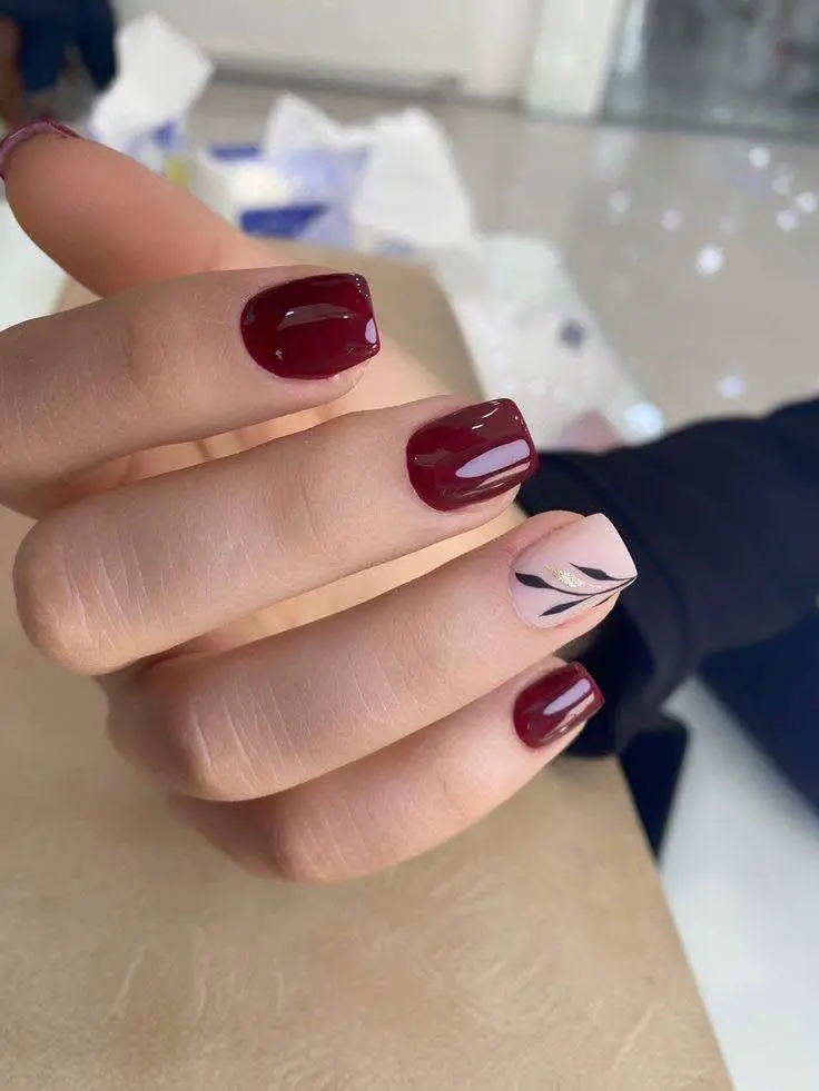 Short Burgundy Nails with Pink and Black Swirl Accent