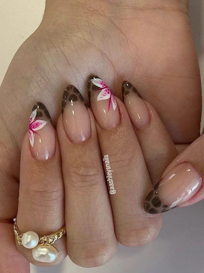 Short nails with tortoiseshell tips and pink and white flower nail art.