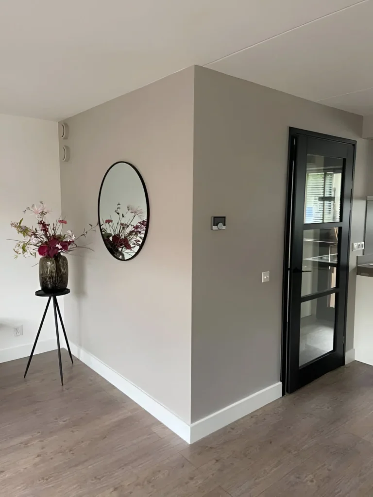 Interior view with warm gray walls and light wood floors.