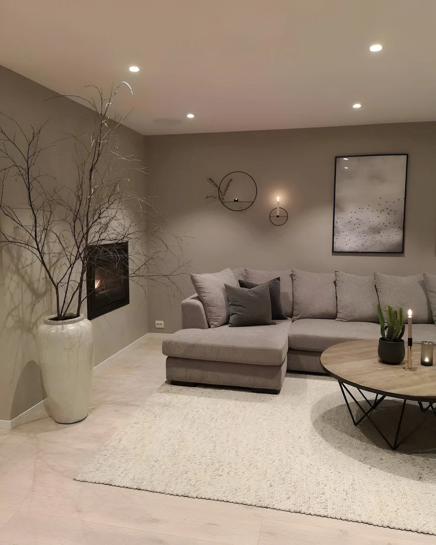 Minimalist living room with soft gray walls and simple furnishings.