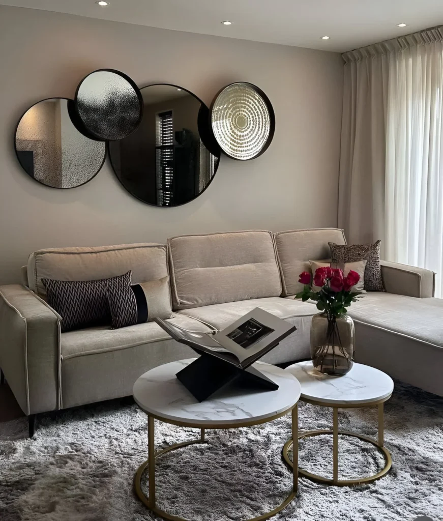 Living room featuring textured neutral walls and mirrored accents.