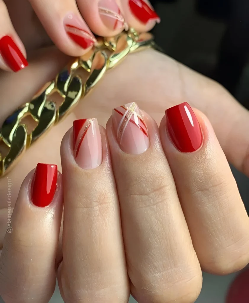 Trendy red nail design with minimalist gold lines.