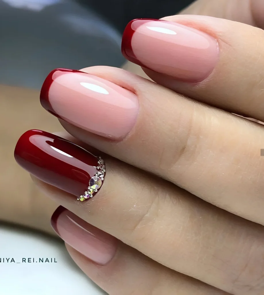 Burgundy French manicure with crystal accents – a luxurious 2025 nail trend.