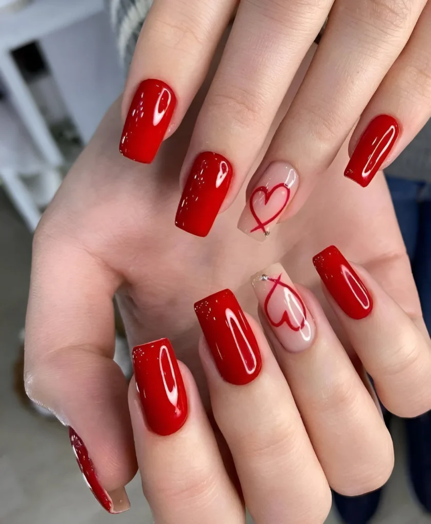 Romantic red nails with nude heart accent nails and crystal details – 2025 trend.