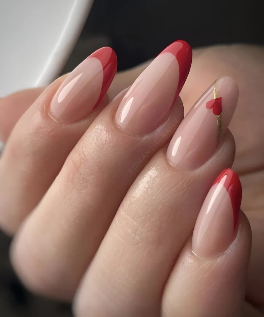 Red slanted French tip nails with heart detail.