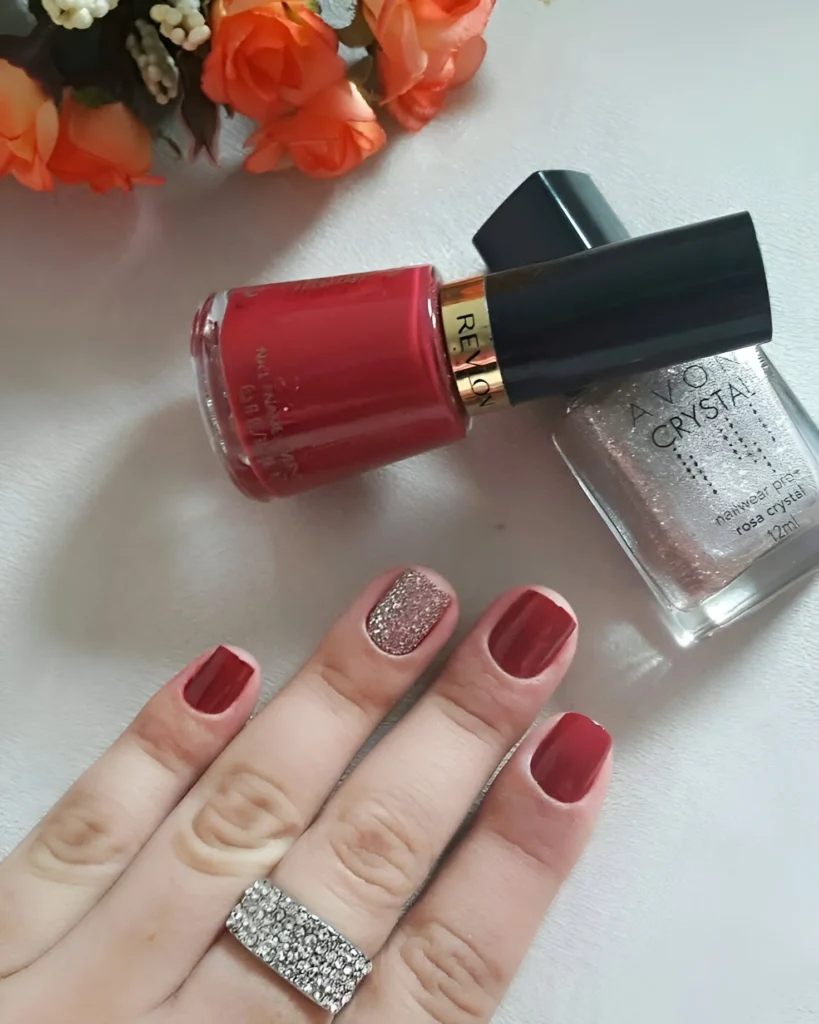 Simple red nails with subtle glitter gradient accent.