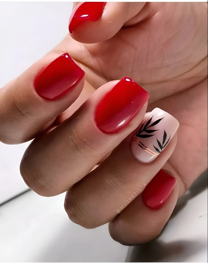 Red nails with black botanical silhouette accent.