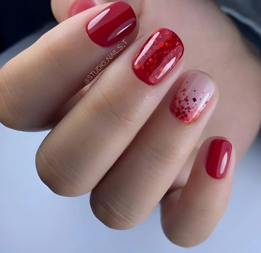 Red nails with glitter accent nail, perfect design.